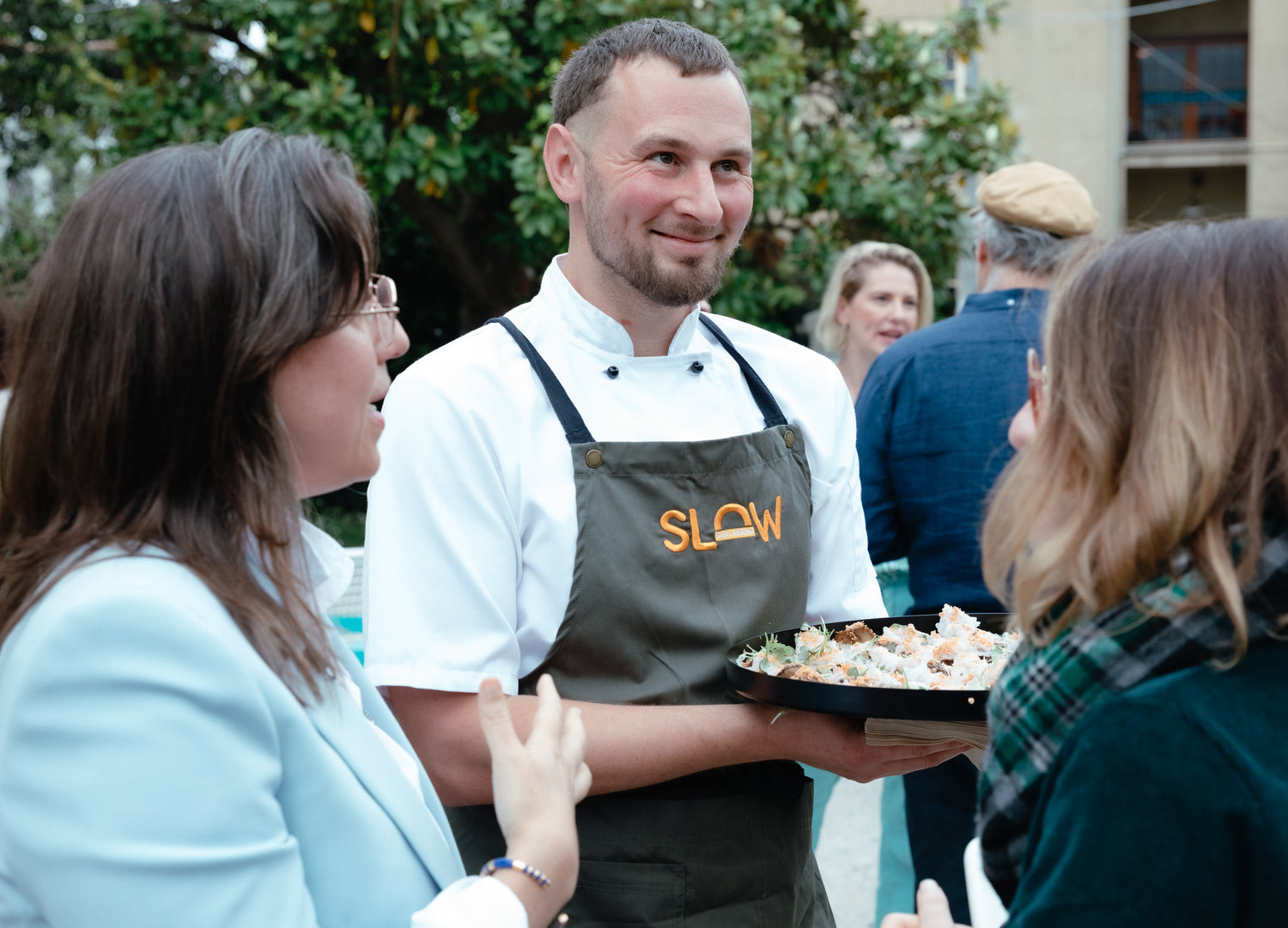 Chase serving canapes at Ester Perells' podcast recording at the White house st kilda for Small Giants Academy. The black tray has confit Ottoway shiitake mushrooms with white fungus, mushroom floss and a crispy sesame rice cracker.