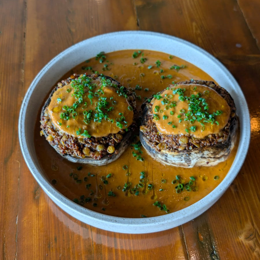 Stuffed mushrooms with a creamy sauce on a wooden table